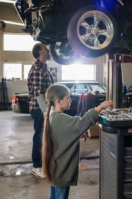 Father and daughter bonding in a garage while working on a car, emphasizing family and teamwork.
